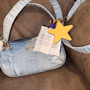 Coach in loved denim with some charms